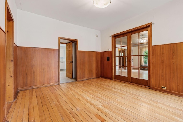 518 32nd St, Minneapolis, MN 55408 - spare room featuring wainscoting, wood walls, light wood-style floors, and french doors