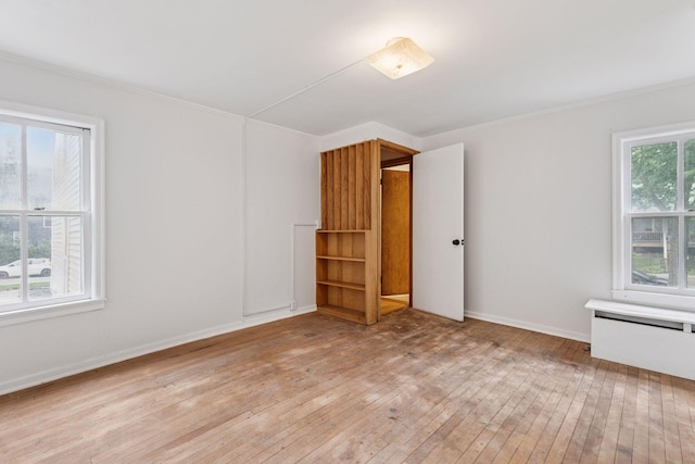 518 32nd St, Minneapolis, MN 55408 - unfurnished bedroom featuring light wood-style flooring and crown molding