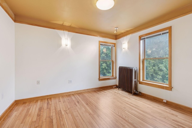 518 32nd St, Minneapolis, MN 55408 - spare room with radiator and light wood-style floors