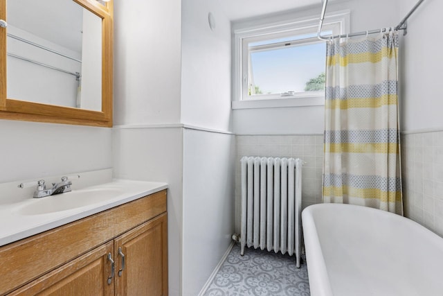 518 32nd St, Minneapolis, MN 55408 - bathroom featuring radiator, a soaking tub, and vanity