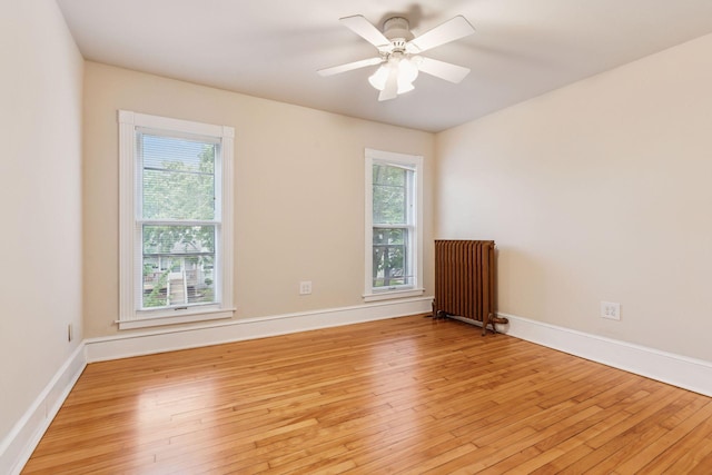 518 32nd St, Minneapolis, MN 55408 - empty room featuring radiator, light wood finished floors, and ceiling fan
