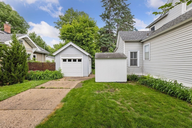 518 32nd St, Minneapolis, MN 55408 - view of grassy yard featuring concrete driveway, an outdoor structure, and a garage