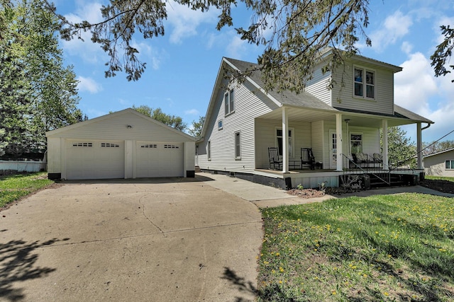 view of front of home with covered porch, an outdoor structure, a garage, roof with shingles, and a front yard