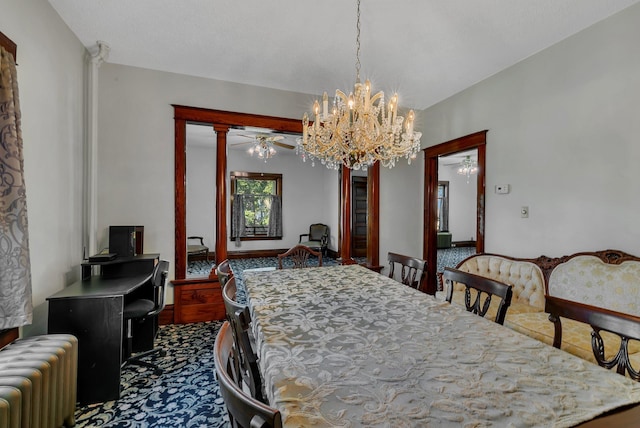 carpeted dining space featuring radiator heating unit, ceiling fan, and a chandelier