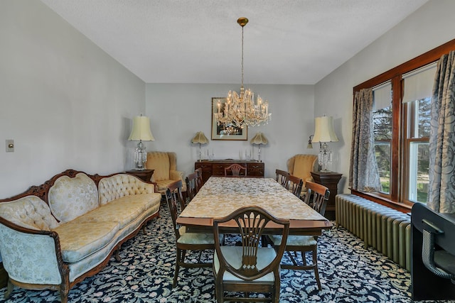 carpeted dining area featuring radiator heating unit, a chandelier, and a textured ceiling