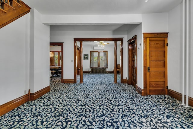 hall featuring carpet and baseboards