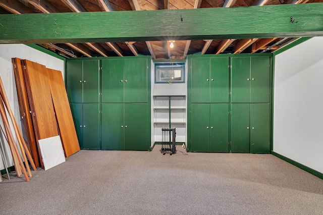 below grade area featuring carpet floors and baseboards