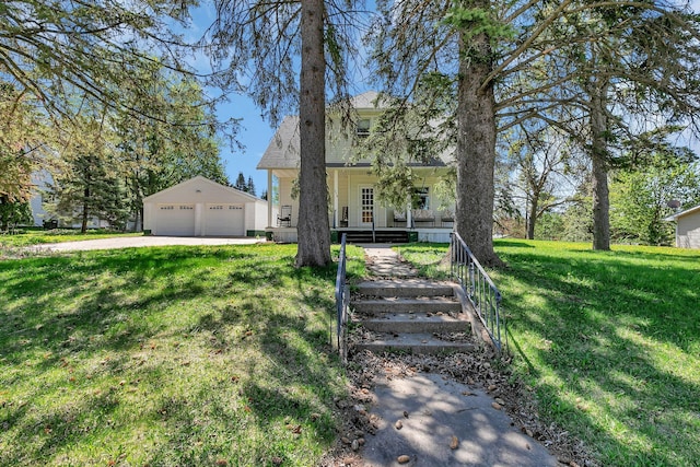 view of front of home with a garage, an outdoor structure, a front lawn, and covered porch