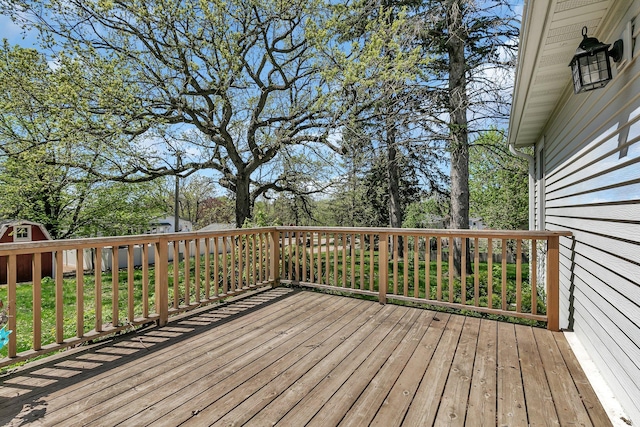 deck featuring view of wooded area