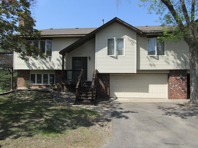 13622 Knox Dr, Burnsville, MN 55337 - split foyer home featuring brick siding, an attached garage, driveway, and a chimney