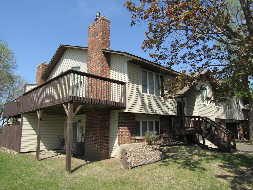 13622 Knox Dr, Burnsville, MN 55337 - back of property featuring brick siding, cooling unit, a yard, a chimney, and a wooden deck
