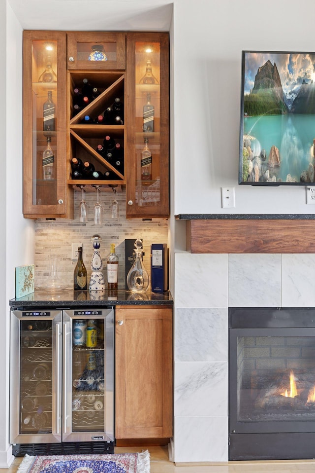 500 Grant St Unit 2509, Minneapolis, MN 55404 - indoor dry bar featuring beverage cooler, decorative backsplash, and a tile fireplace