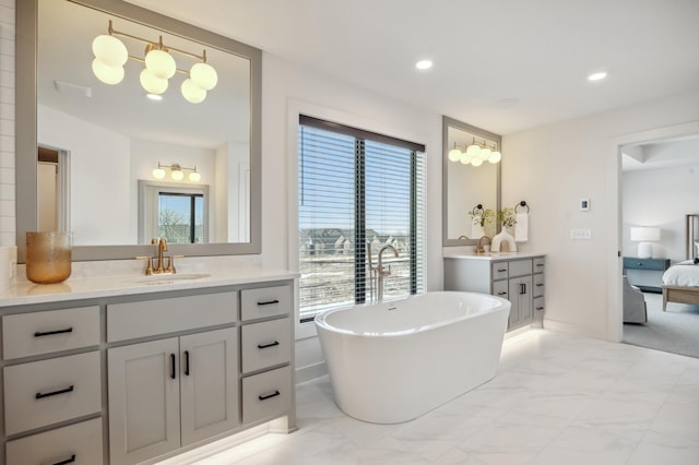 10382 Peony Ln N, Maple Grove, MN 55311 - full bathroom featuring marble look tiles, a freestanding tub, two vanities, recessed lighting, and ensuite bath