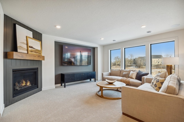 10382 Peony Ln N, Maple Grove, MN 55311 - living room featuring light colored carpet, a fireplace, recessed lighting, baseboards, and a textured ceiling