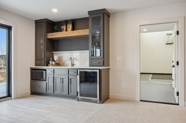 10382 Peony Ln N, Maple Grove, MN 55311 - indoor wet bar with wine cooler, baseboards, built in microwave, and recessed lighting