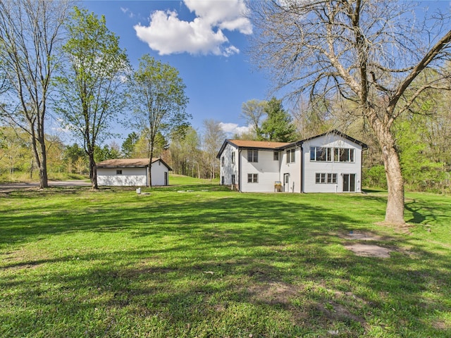 rear view of property with a yard
