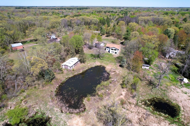 view of property location featuring a heavily wooded area and a large body of water