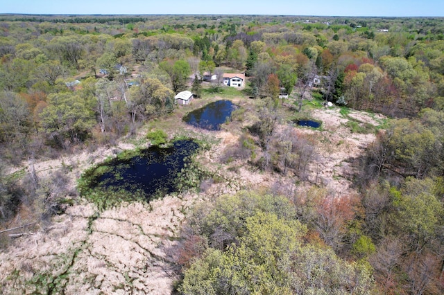 view of property location featuring a forest