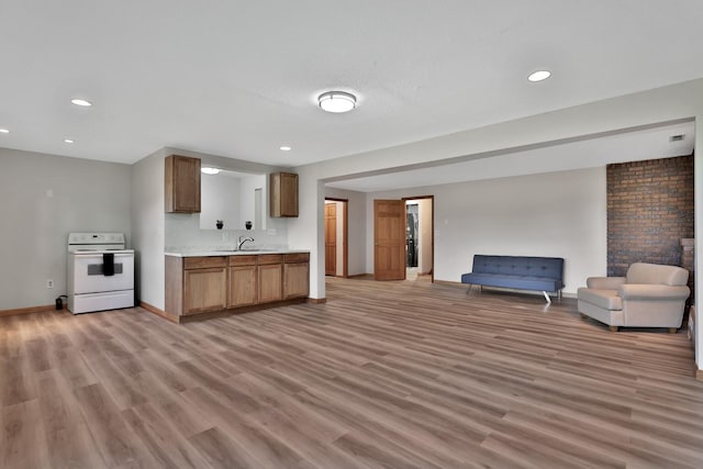 30145 Fir Trl, Stacy, MN 55079 - kitchen with white electric stove, open floor plan, light countertops, light wood-type flooring, and recessed lighting