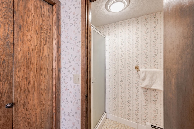 2465 Londin Ln E Unit 212, Maplewood, MN 55119 - bathroom featuring wallpapered walls, a textured ceiling, a stall shower, tile patterned flooring, and baseboards