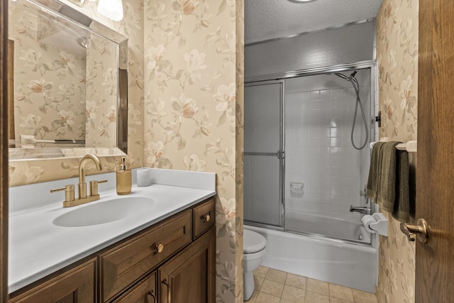 2465 Londin Ln E Unit 212, Maplewood, MN 55119 - bathroom featuring wallpapered walls, toilet, tile patterned floors, vanity, and enclosed tub / shower combo