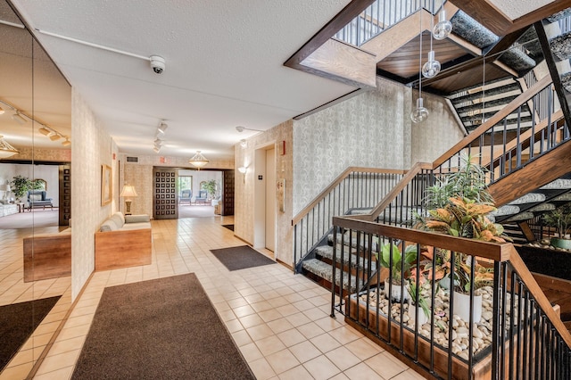 2465 Londin Ln E Unit 212, Maplewood, MN 55119 - common area featuring a security system, wallpapered walls, and stairs