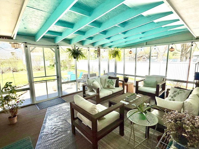 sunroom / solarium with an outdoor living space, plenty of natural light, and beam ceiling