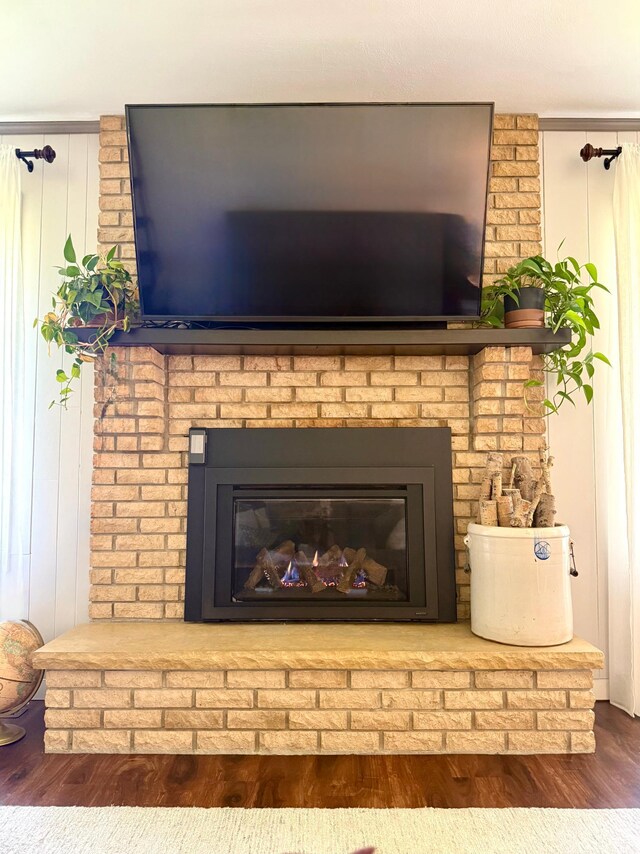 detailed view of a fireplace and wood finished floors
