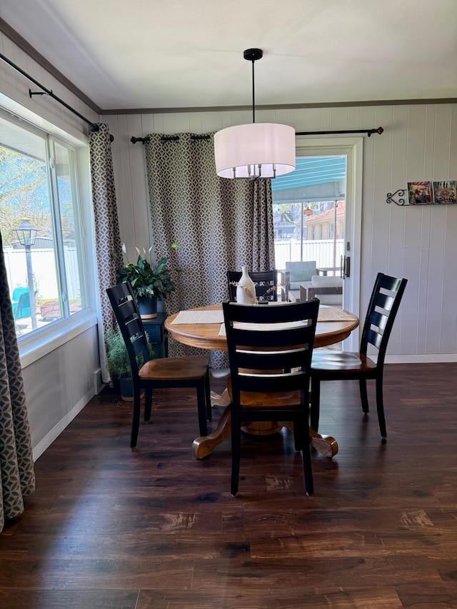 dining area with baseboards, dark wood-style floors, and ornamental molding