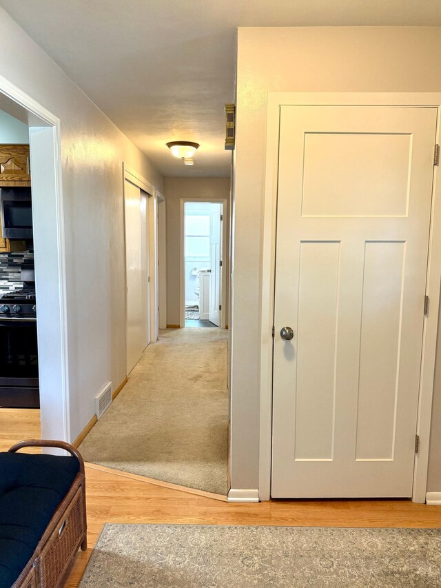 corridor featuring light wood-style floors