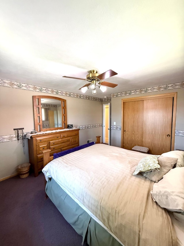 carpeted bedroom with a closet and a ceiling fan