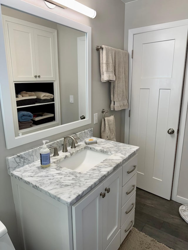bathroom with wood finished floors and vanity