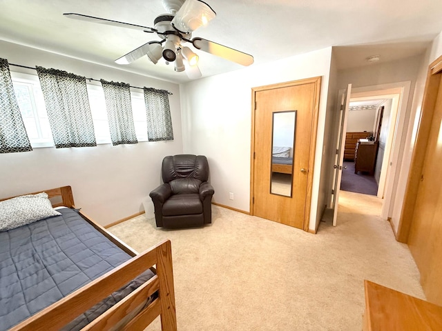 carpeted bedroom with multiple windows, baseboards, and a ceiling fan