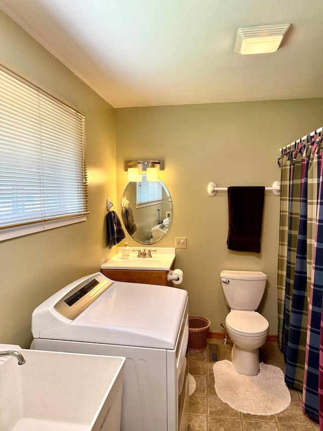 full bathroom with toilet, washing machine and clothes dryer, tile patterned floors, vanity, and curtained shower