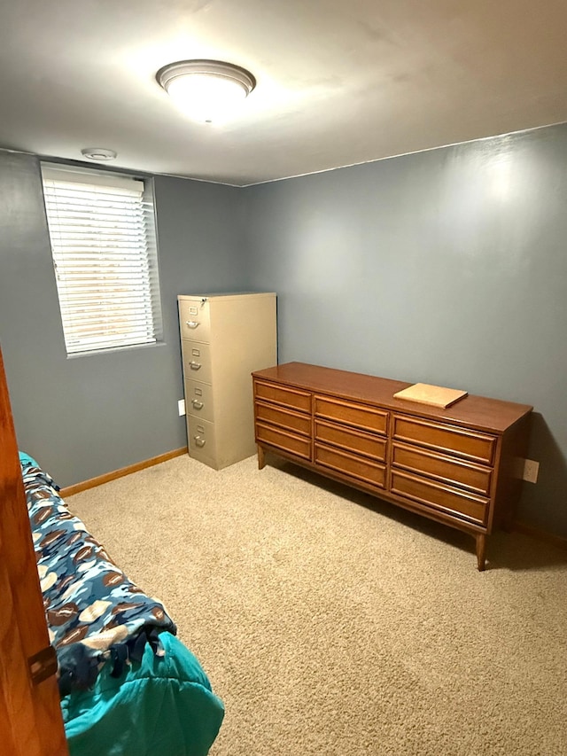 carpeted bedroom featuring baseboards