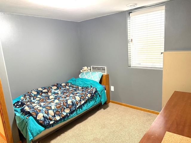 bedroom with multiple windows, baseboards, and carpet floors