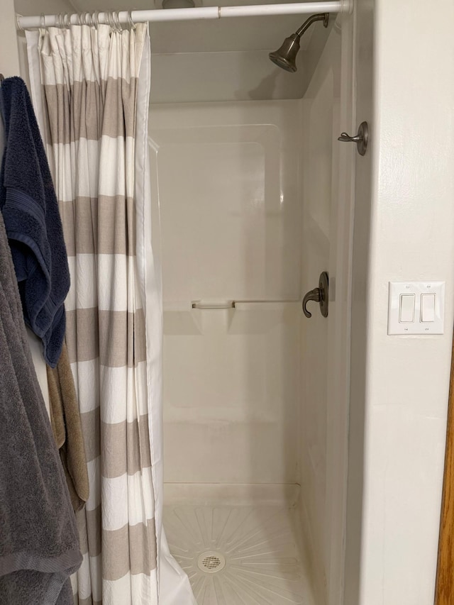 full bath with a shower stall