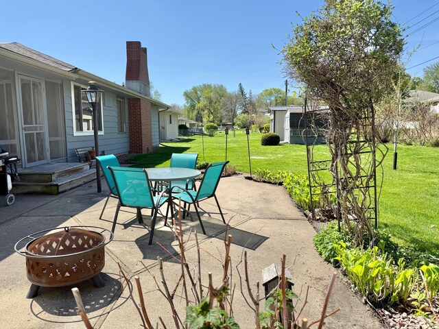 view of patio / terrace with a fire pit and outdoor dining space