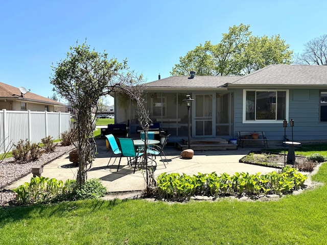 back of house featuring a patio area, a sunroom, entry steps, and a shingled roof