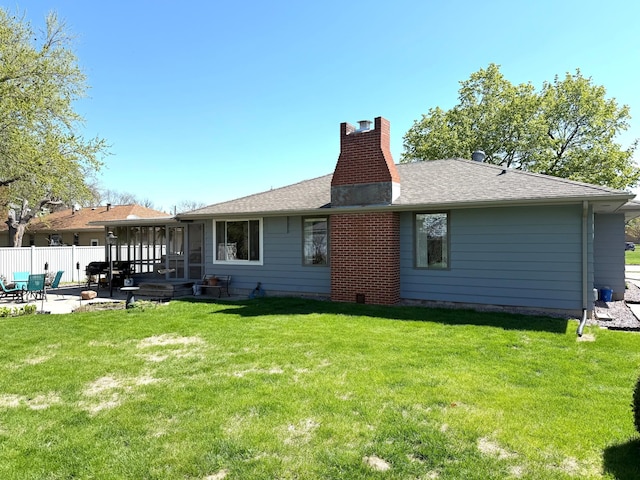rear view of property with a patio and a chimney