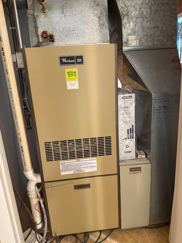 utility room featuring heating unit