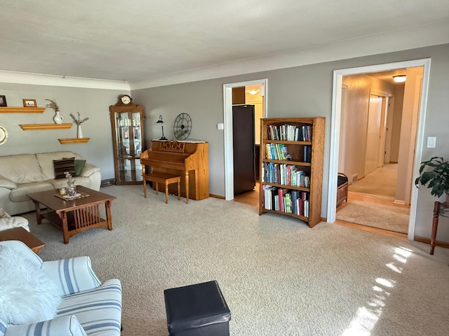 carpeted living room with baseboards