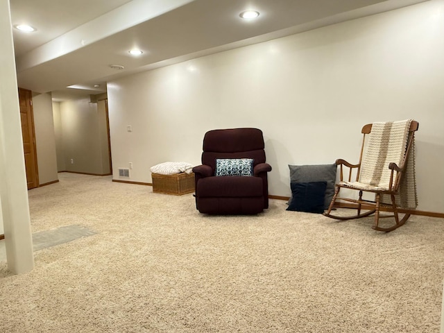 sitting room featuring carpet, baseboards, and recessed lighting