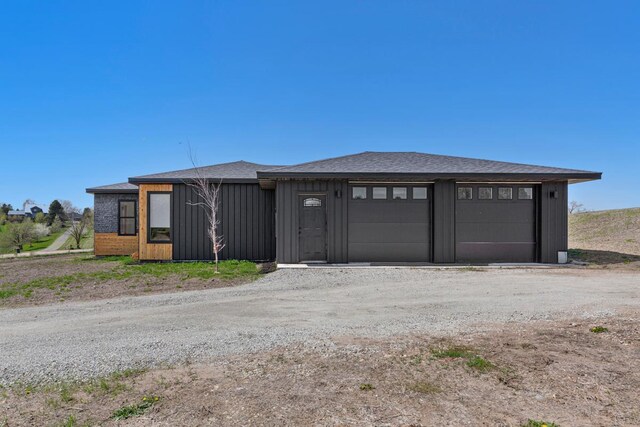 20355 Cedar Lake Trl, Shieldsville Twp, MN 55052 - view of front of home with board and batten siding, a shingled roof, and dirt driveway