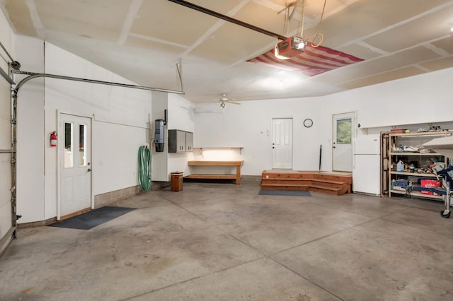 6209 Heather Pl NE, Fridley, MN 55432 - garage with freestanding refrigerator, a garage door opener, and a central vacuum unit