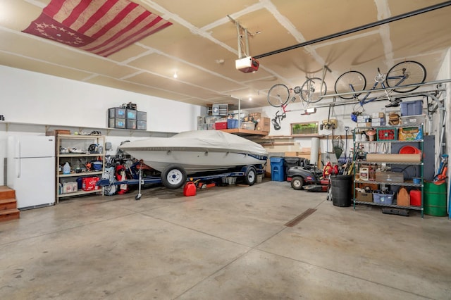 6209 Heather Pl NE, Fridley, MN 55432 - garage with freestanding refrigerator, a garage door opener, and a workshop area