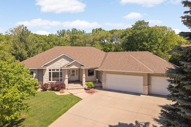 6209 Heather Pl NE, Fridley, MN 55432 - view of front of home featuring driveway, an attached garage, a front yard, stone siding, and stucco siding