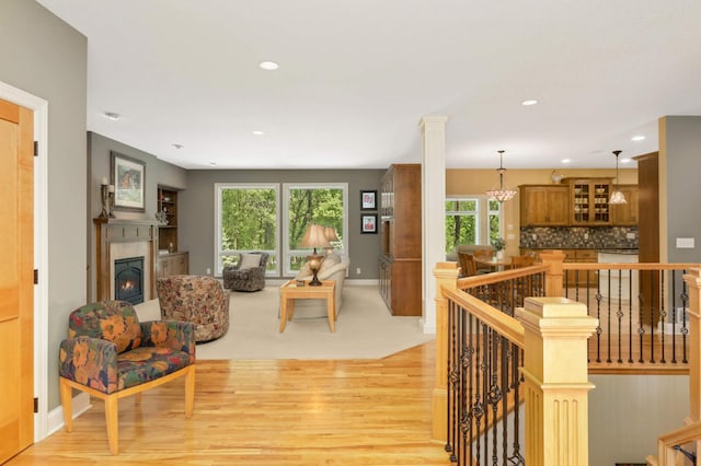6209 Heather Pl NE, Fridley, MN 55432 - living room with light wood-style flooring, baseboards, healthy amount of natural light, a lit fireplace, and recessed lighting