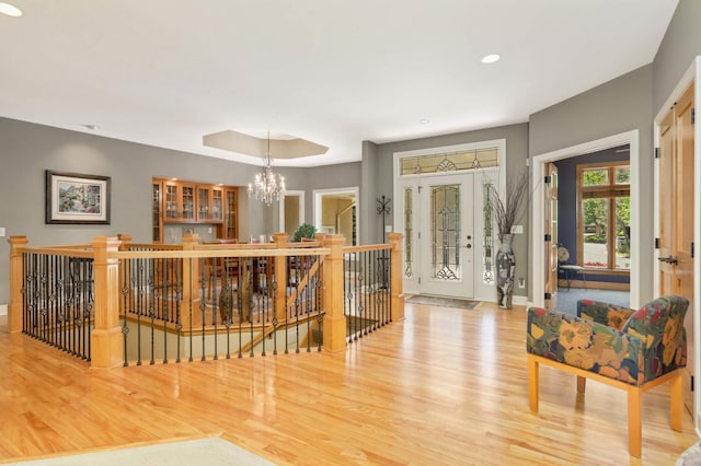 6209 Heather Pl NE, Fridley, MN 55432 - entryway with wood finished floors, a chandelier, recessed lighting, baseboards, and a tray ceiling