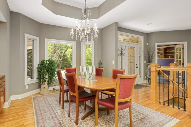 6209 Heather Pl NE, Fridley, MN 55432 - dining room with light wood-type flooring, baseboards, and a chandelier